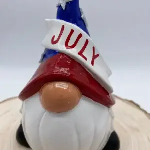 Birthday Gnome for the month of July wearing Red, White, and Blue hat, with silver stars, Front