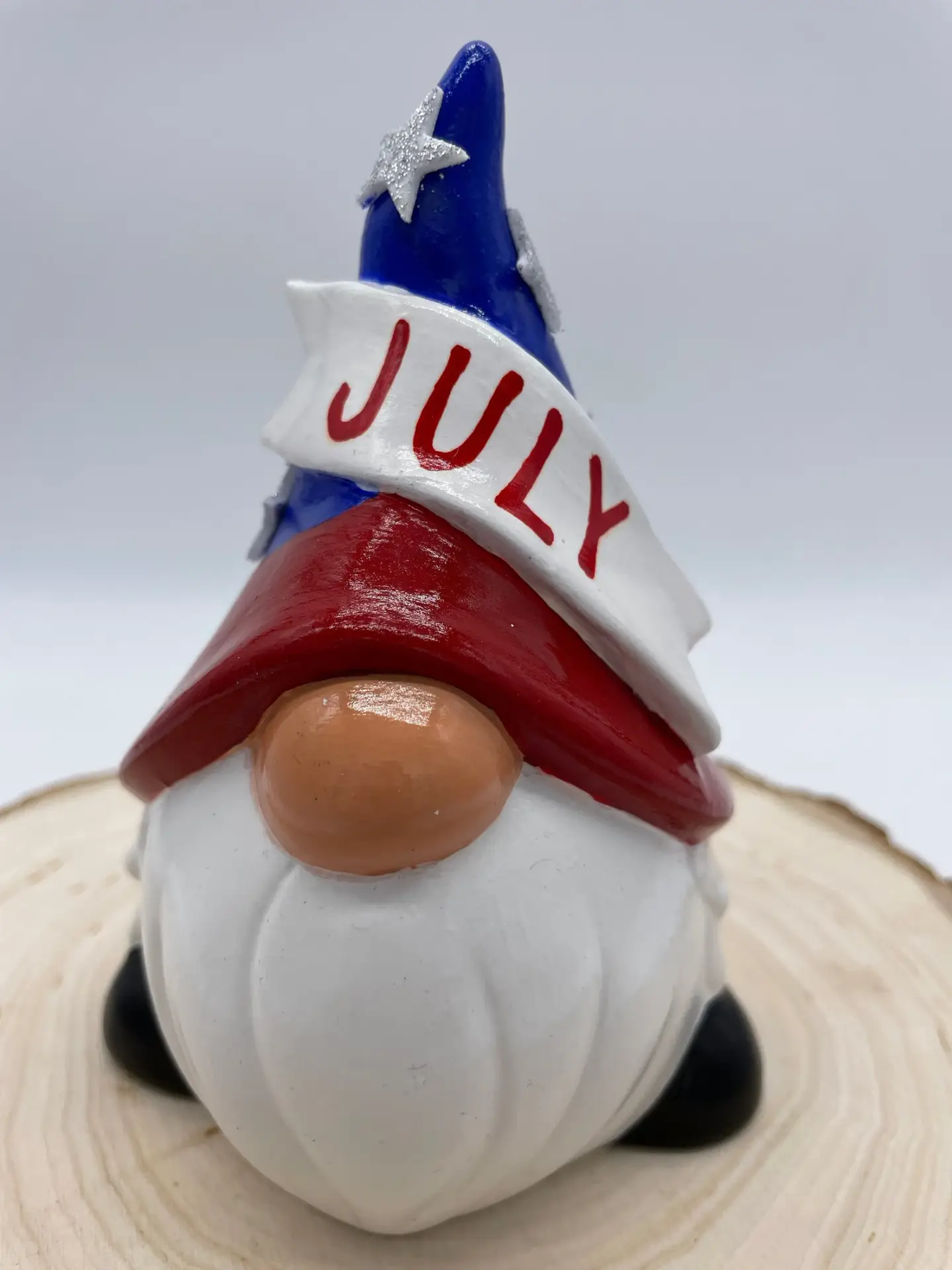 Birthday Gnome for the month of July wearing Red, White, and Blue hat, with silver stars, Front