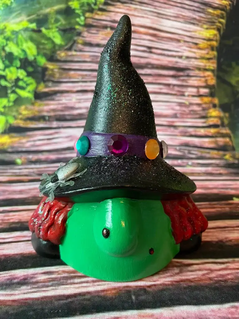 Green Garden Gnome Head with Wicked Witch Features, Black Hat with colorful gems, red wavy hair, Halloween Decor, Front On Terrain