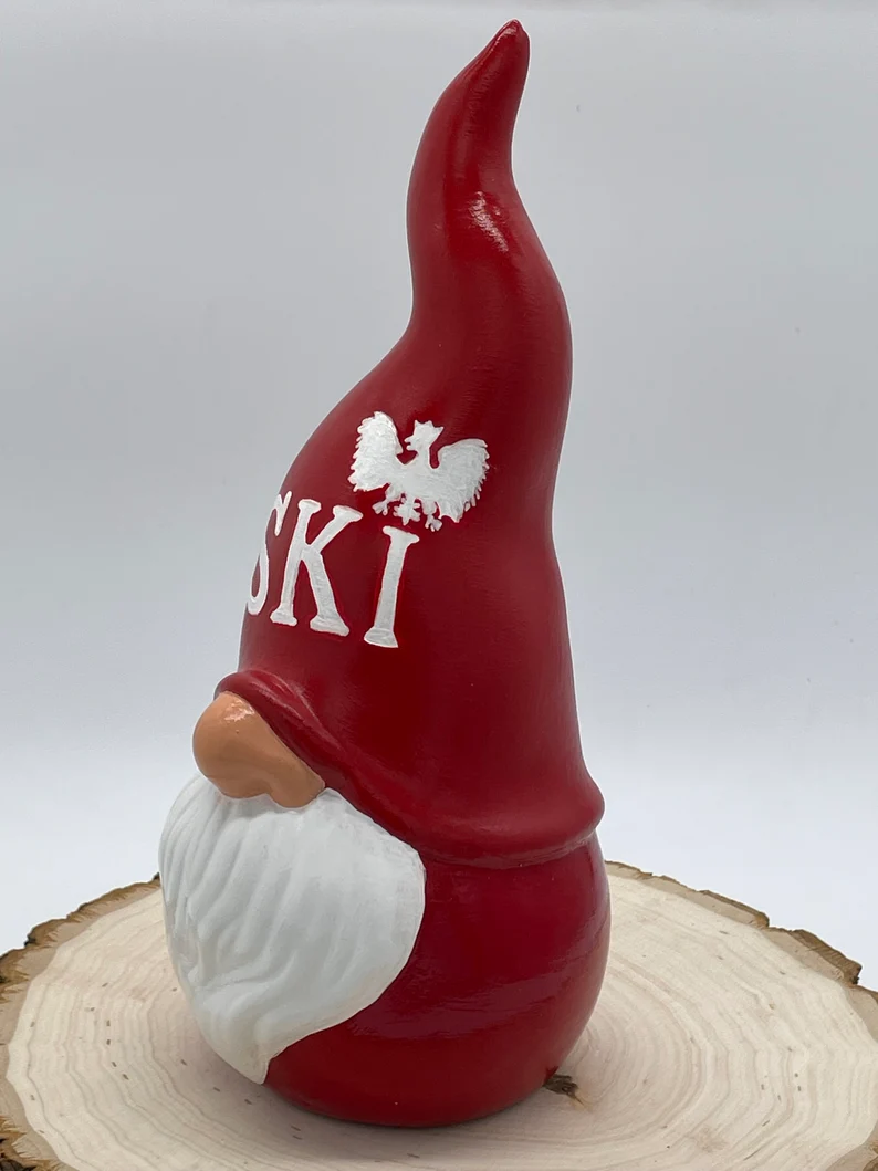 Ceramic Garden Gnome with red hat and clothes, hat says 'Ski' in white with the Polish Eagle above the letter I, Front Left