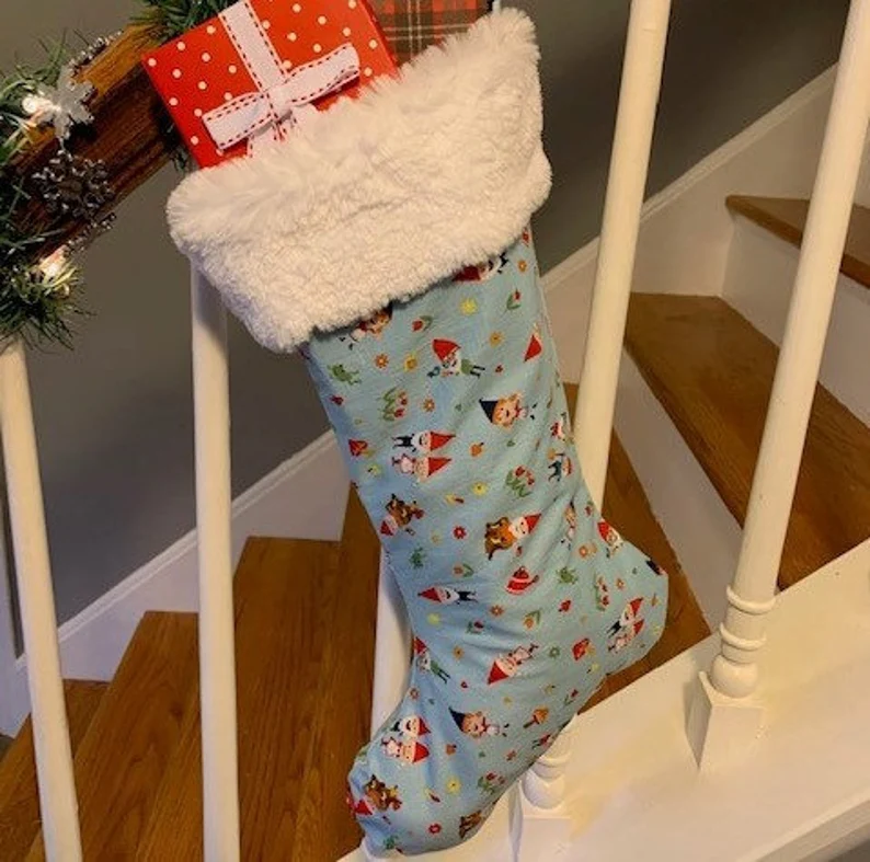 Full light blue Gnome Christmas Stocking with gifts inside, hanging on banister, Full Side